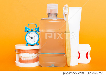 Mouthwash and other oral hygiene products on colored table top view with copy space. Flat lay. Dental hygiene. Oral care kit. Dentist concept Mouthwash and other oral hygiene products on colored table top view with copy space. Flat lay. Dental hygiene. Oral care kit. Dentist concept 123876755
