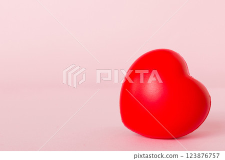 gift box with red bow and red heart on colored background. Perspective view. Flat lay 123876757