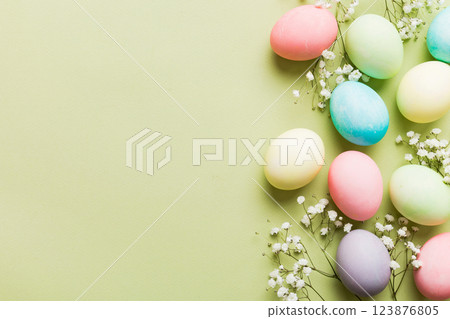 Happy Easter composition. Easter eggs on colored table with gypsophila. Natural dyed colorful eggs background top view with copy space Happy Easter composition. Easter eggs on colored table with gypsophila. Natural dyed colorful eggs background top view with copy space 123876805