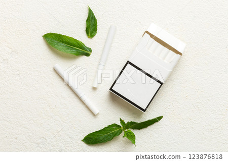 Pack of menthol cigarettes and fresh mint on colored table, Menthol cigarettes top view flat lay 123876818
