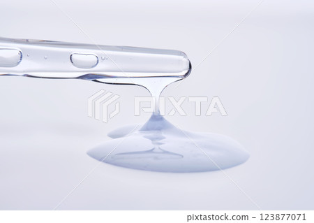 Pipette with delicate blue serum close-up. 123877071