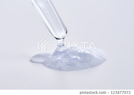 Pipette with delicate blue serum close-up. 123877072