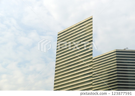 Glass facade of modern skycraper house in big city. Glass facade of modern skycraper house in big city. 123877591
