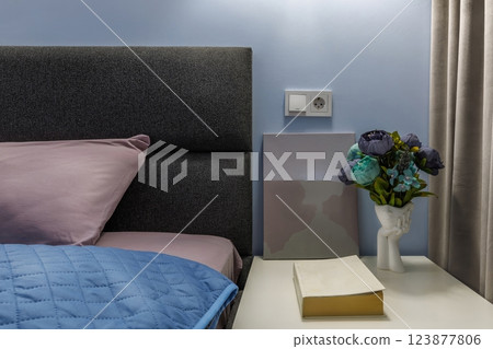 Nightstand with Flower Vase, Book, and Modern Art in Bedroom Nightstand with Flower Vase, Book, and Modern Art in Bedroom 123877806