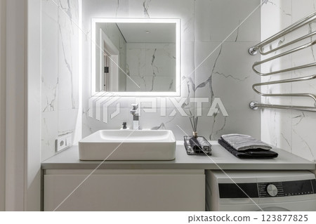 Modern Bathroom with Sink, Mirror, and Towel Rack 123877825