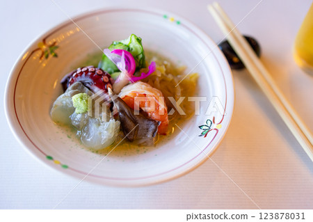 Traditional Japanese appetizer with fresh shrimp, octopus, mollusks, and fermented vegetables 123878031