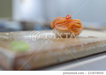 Blood cockle nigiri sushi with precisely cut shellfish on stone plate captured with selective focus 123878050