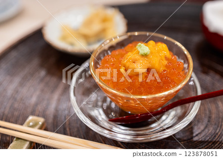 Delicate dish of salmon roe garnished with fresh sea urchin and wasabi elegantly served in a glass bowl Delicate dish of salmon roe garnished with fresh sea urchin and wasabi elegantly served in a glass bowl 123878051