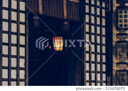 Soft lantern light illuminating the dim interior of a Japanese temple 123878073