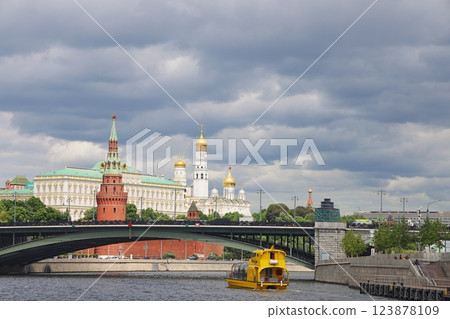 Pleasure boat in front of the Kremlin and Bolshoi Kamenny Bridge, June 2022. Pleasure boat in front of the Kremlin and Bolshoi Kamenny Bridge, June 2022. 123878109