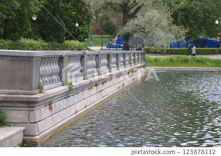 Moscow. Russia. June 15, 2022. People rest on the embankment of the pond in the city park 123878112