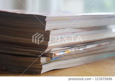 Closeup background of a pile of old magazines with bending pages. Closeup background of a pile of old magazines with bending pages. 123878886