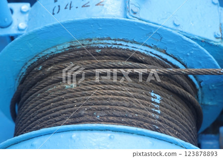The mooring deck of a cargo ship with anchor winches, an anchor chain on winches, ship mechanisms. The mooring deck of a cargo ship with anchor winches, an anchor chain on winches, ship mechanisms. 123878893