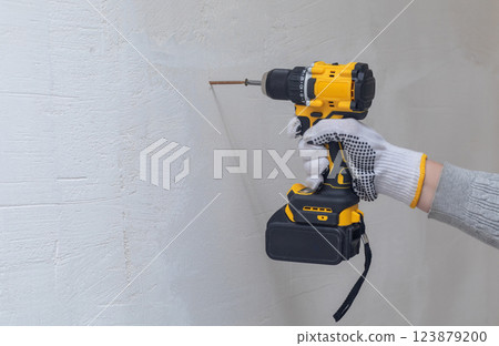 Cordless screwdriver in operation. 123879200