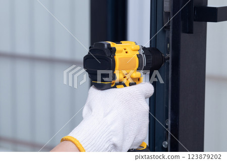 Installation of door hardware. 123879202