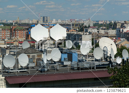 Satellite dishes on house roof 123879621