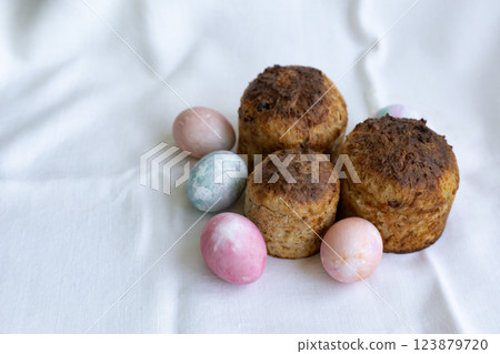three whole wheat Easter cakes and pastel color Easter eggs 123879720