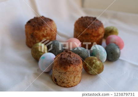 Easter cakes and colorful Easter eggs on a white tablecloth 123879731