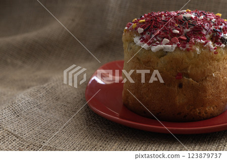 Easter cake with icing on a red plate, close up 123879737