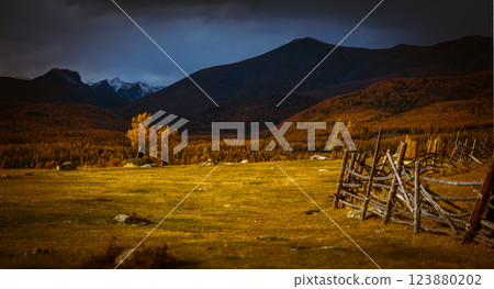Rustic wooden fence on a hilly autumn countryside landscape with distant mountains Rustic wooden fence on a hilly autumn countryside landscape with distant mountains 123880202