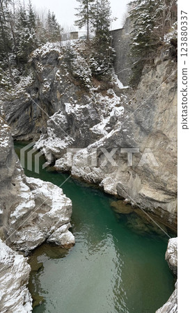 Emerald river Lech flowing through a snowy gorge near Fuessen 123880337