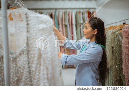 Discover the Elegant Dress Selection Available in the Fashion Boutique Setting 123880924