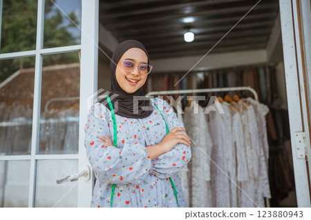 A Stylish Young Woman Wearing a Hijab is Posing Gracefully in a Fashion Boutique A Stylish Young Woman Wearing a Hijab is Posing Gracefully in a Fashion Boutique 123880943