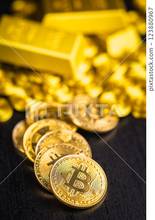 Gold bitcoin coin and gold bars on black table. Gold cryptocurrency. 123880967