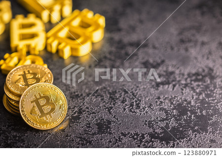 Gold bitcoin coin on black table. Gold cryptocurrency. 123880971