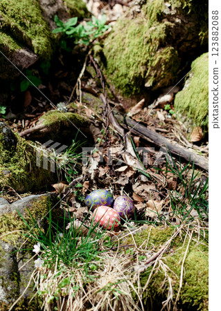 decorated eggs with intricate patterns rest on the dry leaves in forest decorated eggs with intricate patterns rest on the dry leaves in forest 123882088