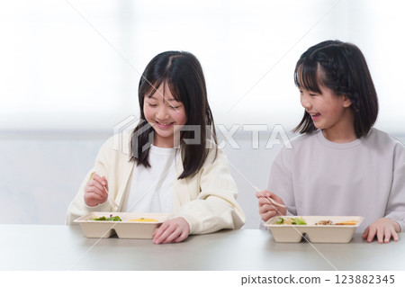 A child eating a delivery lunch at home A child eating a delivery lunch at home 123882345