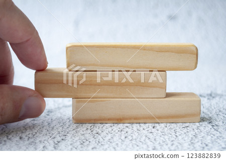 Hand pulling wooden block with customizable space for text. Copy space concept Hand pulling wooden block with customizable space for text. Copy space concept 123882839