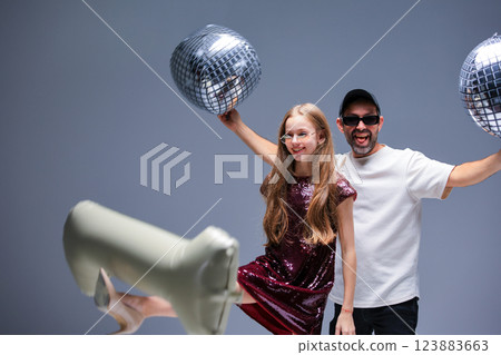 A vibrant celebration with disco balls and joyful dance moves that excite everyone involved A vibrant celebration with disco balls and joyful dance moves that excite everyone involved 123883663