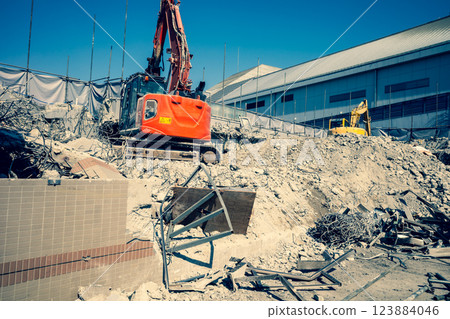 Building demolition site Heavy machinery working on rubble a-3 Warm colors Building demolition site Heavy machinery working on rubble a-3 Warm colors 123884046