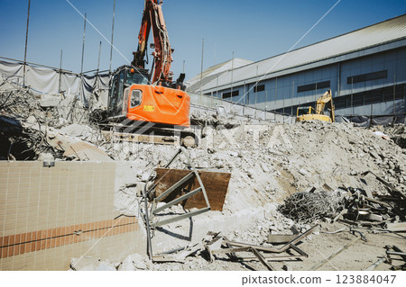 Building demolition site Heavy machinery working on rubble a-4 Film-like Building demolition site Heavy machinery working on rubble a-4 Film-like 123884047