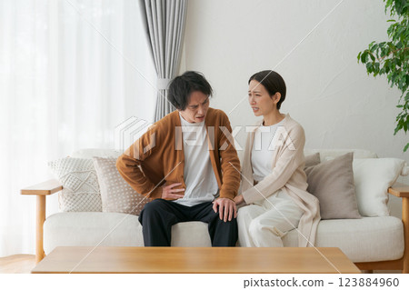 A husband in poor health and a worried wife A husband in poor health and a worried wife 123884960