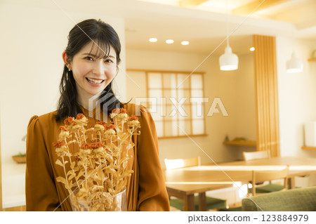 A woman adorning dry flowers A woman adorning dry flowers 123884979