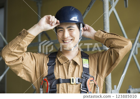 A man working at a construction site A man working at a construction site 123885010