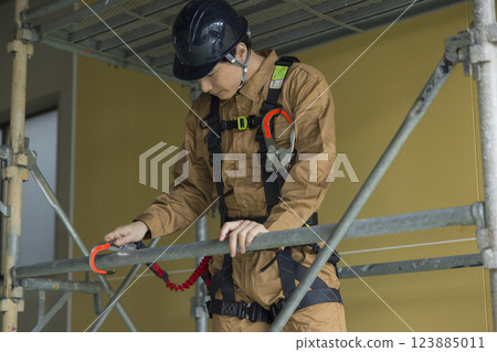 A man working at a construction site A man working at a construction site 123885011