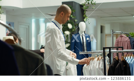 Fashionable expert working in retail to help boutique shoppers, showcasing personalized customer service and style guidance in a trendy mall clothing store. Fashion display in the industry. Camera A. 123886131