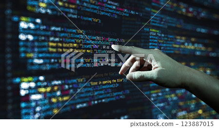 Human hand pointing at the abstract Modern tech of Programming code screen developer. C Programming Language of Computer script and Technology background of software. Human hand pointing at the abstract Modern tech of Programming code screen developer. C Programming Language of Computer script and Technology background of software. 123887015