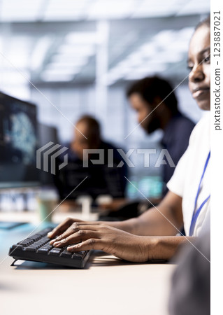 Programmer in server room using artificial intelligence technology for increased productivity in startup workplace. Data center worker implementing AI driven predictive analytics solutions 123887021