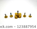 Income inequality and business success - miniature of businessman on gold coins 123887954
