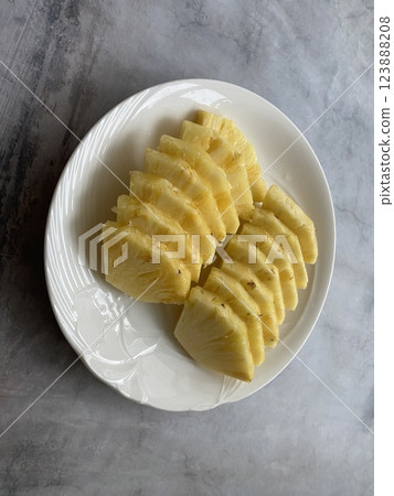 Sliced Pineapple on a White Plate Sliced Pineapple on a White Plate 123888208