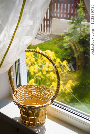 Wooden basket on the windowsill 123889783