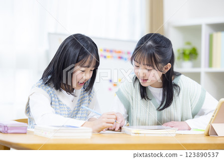 Sisters doing homework in the living room 123890537