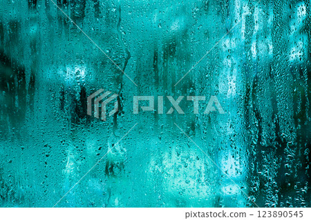 Abstract view of water droplets on a turquoise moist glass surface. Suitable for atmospheric visuals, backgrounds, or conveying a soft, natural mood. blue turquoise background Abstract view of water droplets on a turquoise moist glass surface. Suitable for atmospheric visuals, backgrounds, or conveying a soft, natural mood. blue turquoise background 123890545