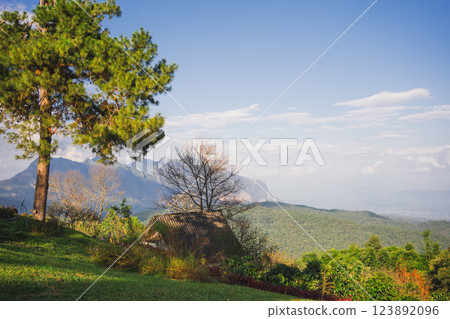 landscape and travel concept with sunlight and cloudy sky with country house on mountain 123892096