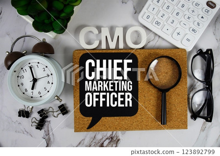 CMO - Chief Marketing Officer acronym with calculator, alarm clock and magnifying glass, Business concept background 123892799