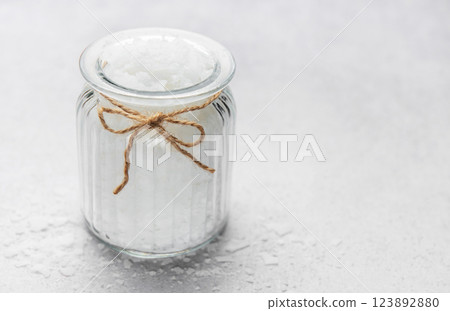 Magnesium flakes inside elegant glass jar with rustic twine on white background Magnesium flakes inside elegant glass jar with rustic twine on white background 123892880